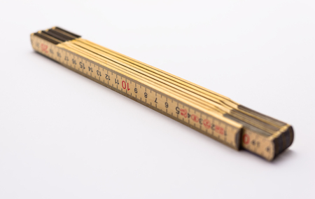 Wooden folding ruler isolated on a white background.