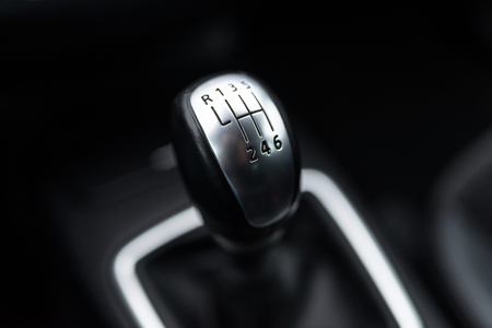 Black interior of a modern car, six-speed manual shift car gear lever.の素材 [FY310116641243]