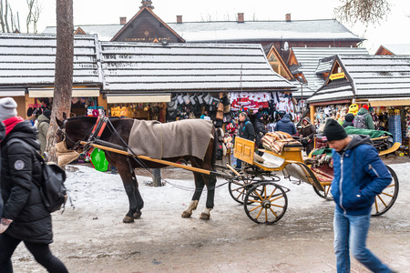 Zakopane, Poland - February 21, 2019. Horse carriage, standing on Krupowki street in Zakopane.のeditorial素材