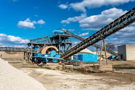 Machine for transferring gravel, spoil for transport on an industrial cement plant.の写真素材