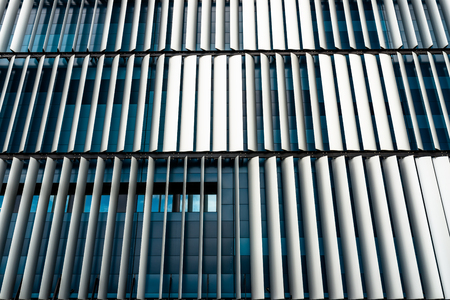 The facade of a modern building with an innovative facade made of automatic, movable blinds.