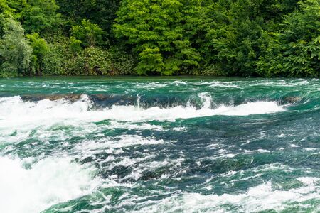 A beautiful waterfall on the river Rhine in the city of Neuhausen am Rheinfall in northern Switzerland. The Rhine Falls is the largest waterfall in Europe.の写真素材