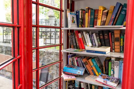 Konigswinter, Germany - 23 May 2019. A red telephone booth for the free exchange of books.のeditorial素材