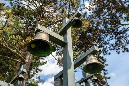 Ysselsteyn, Netherlands - May 23, 2019. Church bells arranged on masts, on the German war cemetery in the Netherlands.のeditorial素材