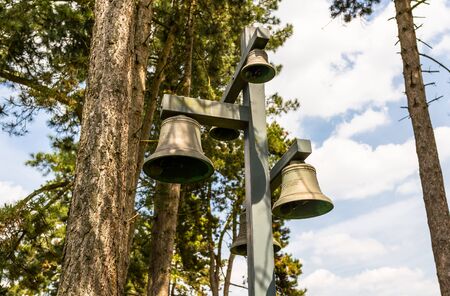 Ysselsteyn, Netherlands - May 23, 2019. Church bells arranged on masts, on the German war cemetery...