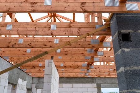 Roof trusses not covered with ceramic tile on a detached house under construction, visible roof...