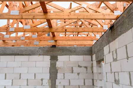 Roof trusses not covered with ceramic tile on a detached house under construction, visible roof elements, battens, counter battens, rafters.の写真素材