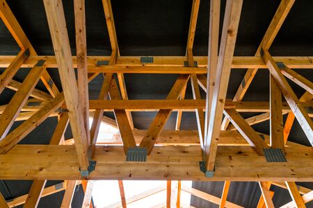 Roof trusses covered with a membrane on a detached house under construction, visible roof elements,...