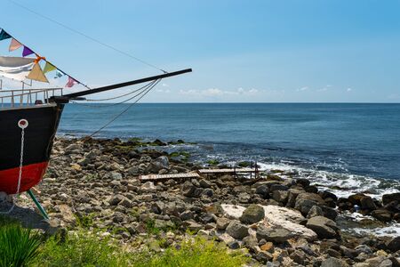 Rocky shore over the beautiful Black Sea, in Nessebar, Bulgaria. In the background a sky with...