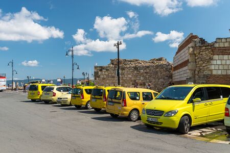 Nessebar, Bulgaria July 15, 2019. Yellow taxis are waiting at the entrance to the historic city of Nessebar in Bulgaria on the shores of the Black Sea.のeditorial素材
