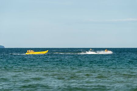 Sunny Beach, Bulgaria July 13, 2019. Inflatable recreational banana boat with people towed by a motorboat in the Black Sea on the shores of Sunny Beach in Bulgaria.のeditorial素材