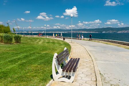 Nessebar, Bulgaria July 11, 2019. Road on the shores of the Black Sea leading from Sunny Beach to the historic city of Nessebar in Bulgaria. Visible concrete bench with a wooden seat.のeditorial素材