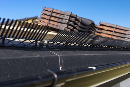 Roof ceramic tile arranged in packets on the roof on roof battens. Preparation for laying roof tiles.の写真素材