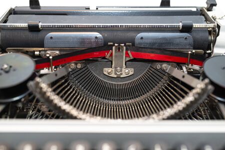 Classic, manual typewriter in white with a German keyboard layout, isolated on a white background...