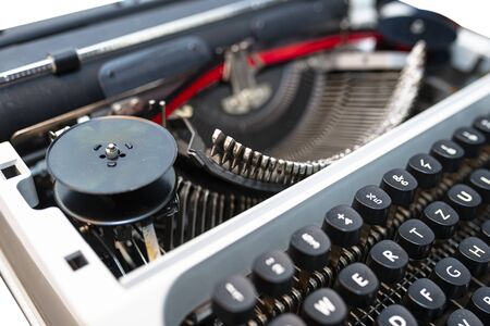 Classic, manual typewriter in white with a German keyboard layout, isolated on a white background...