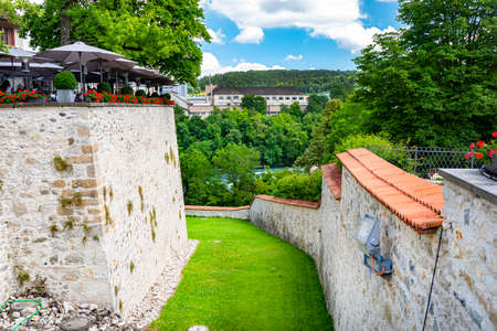 High walls in the ancient castle between which grows grass, a restaurant visible upstairs.のeditorial素材