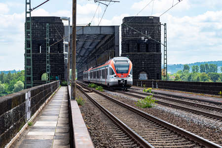Koblenz Germany, 22 June 2020. An electric passenger train belonging to the VIAS GmbH carrier, entering the railway bridge in Koblenz in western Germany, visible railway traction.のeditorial素材
