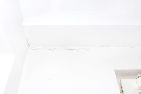 Longitudinal crack in the lintel wall above the window inside the residential building.