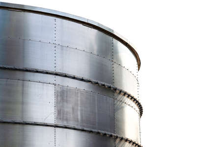 Steel industrial silos for liquids and solids standing in a factory, white sky in the background.の写真素材