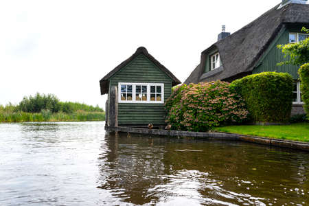 Giethoorn, Netherlands - 13 September 2020. Beautiful thatched buildings in the famous village of Giethoorn in the Netherlands with water canals. The village is called the Venice of the Netherlands.のeditorial素材