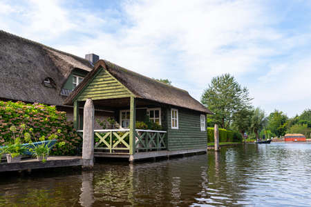 Giethoorn, Netherlands - 13 September 2020. Beautiful thatched buildings in the famous village of Giethoorn in the Netherlands with water canals. The village is called the Venice of the Netherlands.のeditorial素材