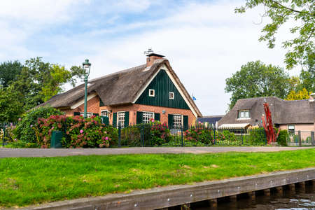 Giethoorn, Netherlands - 13 September 2020. Beautiful thatched buildings in the famous village of Giethoorn in the Netherlands with water canals. The village is called the Venice of the Netherlands.のeditorial素材