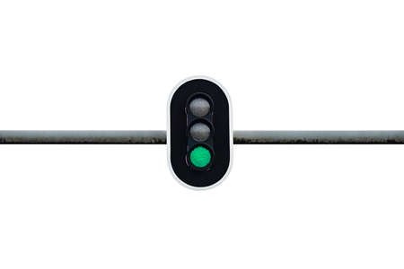 Traffic light showing green color, mounted above the road on a metal scaffold, isolated on a white...