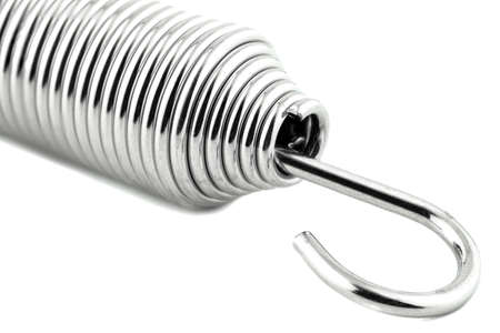 A macro shot of one new steel spring, isolated on a white background.の写真素材