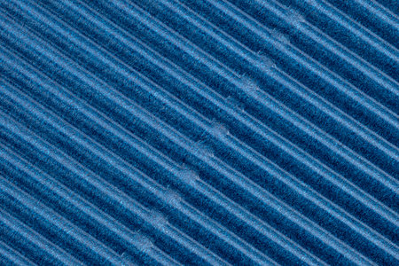 Background made of blue corrugated cardboard with diagonal stripes, view from above.の写真素材