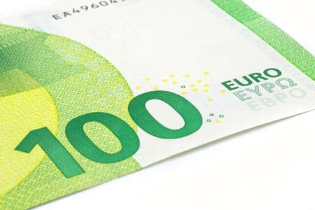 Macro shot of a European Union banknote of 100 EUR, close-up of the number one hundred, isolated on a white background, selective focus.の写真素材