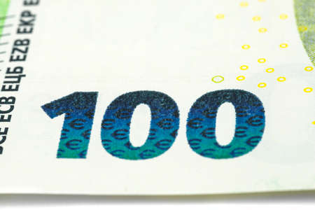 Macro shot of a European Union banknote of 100 EUR, close-up of the number one hundred, selective focus.の写真素材