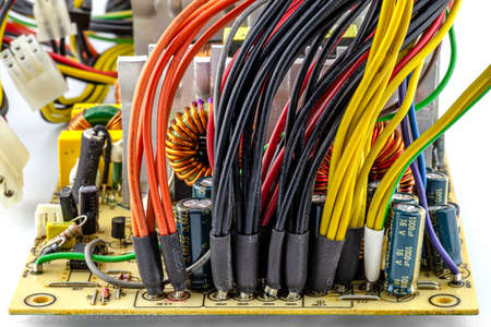 An open 220 volt computer power supply with visible wires coming out to power the computer components from the circuit board.の写真素材
