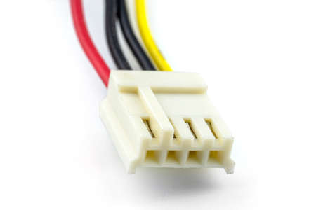 A four-pin female plug for powering a floppy drive coming from a computer power supply, isolated on a white background.の写真素材