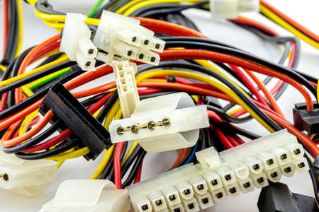 Background made of different kinds of power cables from computer power supply to computer components, isolated on a white background.の写真素材