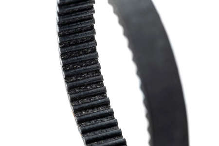 A macro photo of a toothed belt, isolated on a white background.