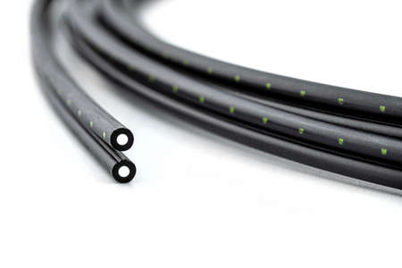 Macro photo of two cut ends of a fiber optic cable, isolated on a white background.