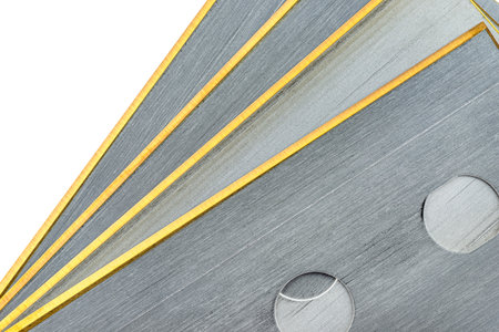 Background made from a macro photo of pile of razor blades with yellow blades, isolated on a white...