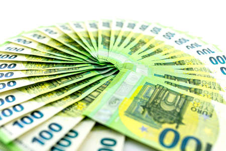 Macro photo of the European Union 100 EURO banknote, bills arranged in a fan, isolated on a white...