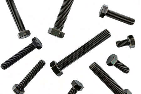 Background made of black screws with a hardness of 4.8, isolated on a white background, visible...