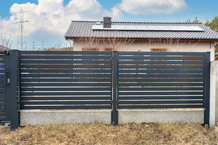 Modern anthracite panel fencing, visible spans and a fence foundation connector, view from the garden.の写真素材