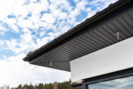 A modern graphite roof lining is attached to the trusses, visible cables and holes for LED lights.