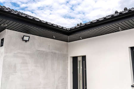 A modern graphite roof lining is attached to the trusses, visible cables and holes for LED lights.
