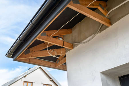 Electric socket mounted on the trusses above the garage door, electric cable in pvc pipe.