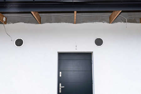 Air intake and exhaust in the wall of a single family house for mechanical ventilation with heat...