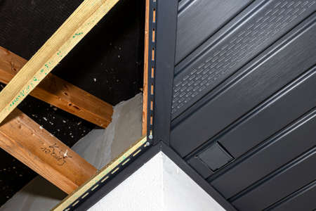 Scaffolding with three rows of wooden battens and a modern graphite soffit, visible H and J slats...