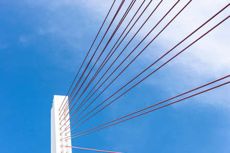 A large cable-stayed bridge on the German motorway over the river Rhine, set against a blue sky.の写真素材