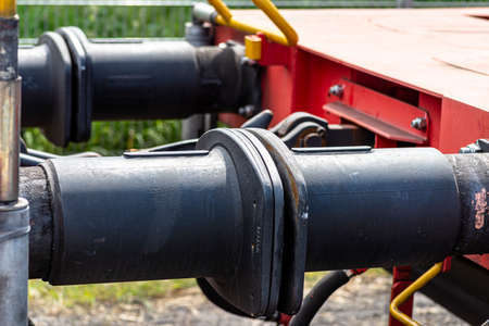 Chain coupler connecting freight wagons, large wagon buffers visible.の写真素材