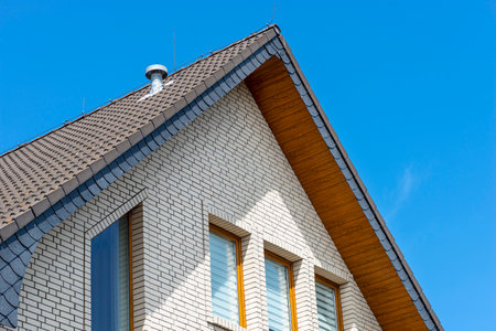 The church has a classic PVC soffit that imitates wood with a white brick facade.の写真素材