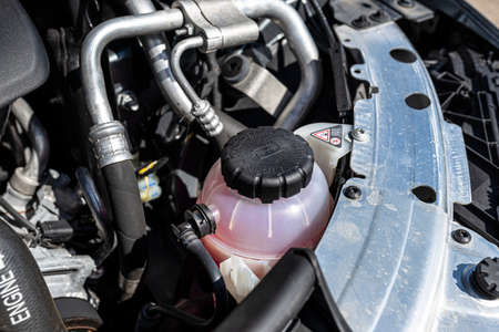 Pink main diesel coolant reservoir located on the right side of the engine compartment.の写真素材