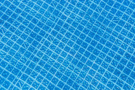 Background made from the bottom of a garden pool, visible rubber bottom in squares.